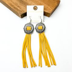 Silver concho dangle earrings with yellow tassels. These earrings are pictured on a white background with a brown block at the top of the picture. Adjustable Fringe Tassel Dangle Earrings, Southwestern Tassel Earrings, Concho Jewelry, Crystal Outline, Nail Necklace, Horse Shoe Nails, Seed Beaded Necklace, Concho Earrings, Necklace With Stone