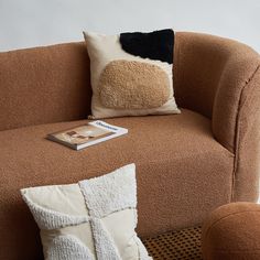 a brown couch with pillows and a book on it for $ 0 99 per square