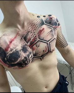 a man's chest covered in blood and ink