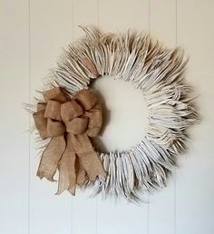 a burlap wreath hanging on the wall