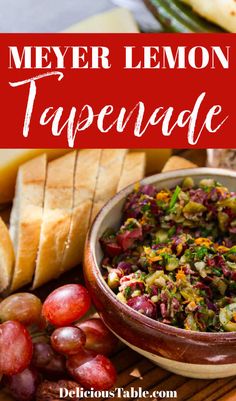 a bowl filled with food next to bread and grapes on a cutting board in front of the words, meyer lemon tapenade