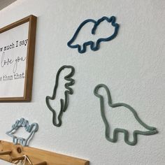 three cookie cutters sitting on top of a wooden shelf