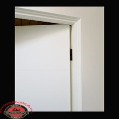 an open door in a room with white walls and black trim on the bottom half