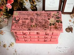 a pink box with writing and flowers on it