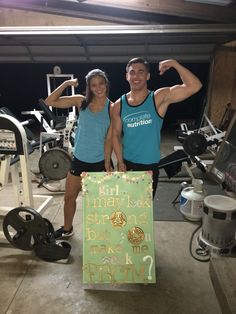 a man and woman standing next to each other in front of a gym equipment rack