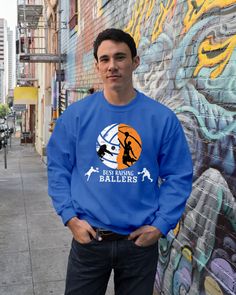 a man standing in front of a wall with graffiti on it and his hands in his pockets