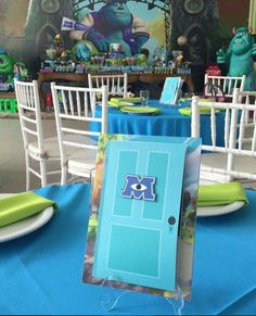 there is a blue door on the table at this birthday party with monsters in the background