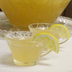 two glasses filled with lemonade sit on a table