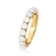 a gold ring with white pearls