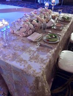 the table is set with flowers and candles