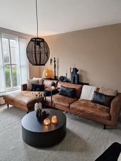 a living room filled with furniture and a large window next to it's wall