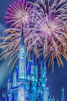 fireworks in the sky above a castle with turrets