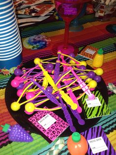 a table topped with lots of toys on top of a colorful cloth