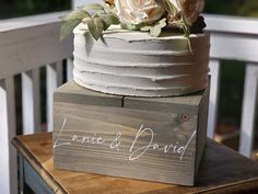 a wedding cake sitting on top of a wooden box