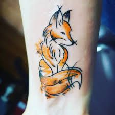 a small tattoo on the ankle of a person with an orange and black fox design