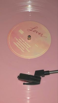 a pink record with the word love written on it