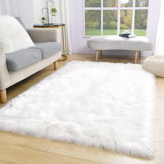 a living room with a white rug on the floor