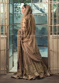 Premium Designer Golden Indian Bridal Dresses has a Meysuri zardozi worked shirt with heavily embellished handwork dupatta in the Golden french net. This outfit is beautifully coordinated with a self jamawar lehenga that is accentuated with two colors appliqued pattern on the daaman and dotted with gorgeous kamdaani. Shirt: This wedding season, create a blissful aura with the treasure of love and grace which is represented through this dress. An artistic vision of Golden Indian Bridal Dresses st Pink Gharara, Gharara Dress, Nameera By Farooq, Boss Lady Style, Gold Lehenga, Eid Dress, Nikkah Dress, Pakistani Couture, Indian Bridal Dress