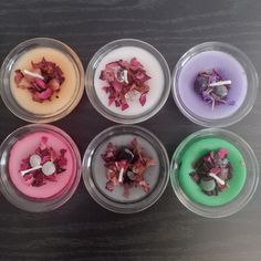 six candles with different colored wax in them