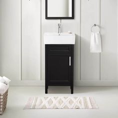 a bathroom with a sink, mirror and towel rack on the wall next to it