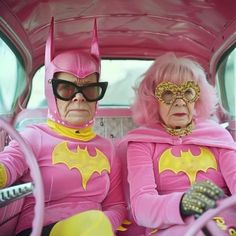 two people dressed as batman and pink are sitting in the back seat of a car