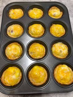 muffins in a pan with cheese on top