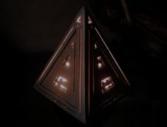 a triangle shaped object with lights on it