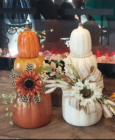 three decorative pumpkins are sitting on a table