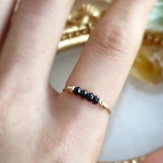 Raw Black Tourmaline Bar Ring ✨Handmade with 14K Gold Filled, Rose Gold Filled, Sterling Silver, Dainty Gemstone Ring🖤 Simple design stacking ring with genuine black tourmaline. Very dainty and cute ring for everyday wear.• Gemstone Size: 4 mm• Ring Band: 0.8 mm🖤 Black tourmaline is a protective stone that helps to remove negative energies within a person or space. It will cleanse, purify, and transform dense energy into a lighter vibration. Perfect for empath protection. 🖤• Handmade in your Dainty Adjustable Black Ring, Dainty Black Adjustable Rings, Adjustable Black Dainty Ring, Adjustable Black Spinel Jewelry For Gifts, Minimalist Black Sapphire Ring For Gift, Minimalist Black Sapphire Ring As Gift, Black Dainty Stackable Jewelry, Dainty Black Stackable Jewelry, Black Dainty Ring As Gift