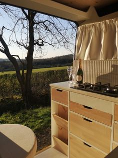 a kitchen with a stove top oven sitting next to a window