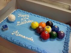 a birthday cake with pool balls and billiards on the side, in a box