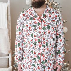 Perfect for snuggling up by the fire with a warm cup of cocoa, this adult pajama set is sprinkled with the sweetest Christmas cookies to bring some festive fun to your holiday season! This long sleeve pajama set with a button-up design fits both men and women, and has a classy collar to elevate your family matching look to make for the perfect Christmas card photo. Made from soft bamboo, these pajamas will keep you cozy throughout every winter wonderland, and were made for family matching fun. Whether you're watching your little ones open presents on Christmas morning or chestnuts roast by the open fire, these cookie PJs are the secret ingredient you've been looking for for a magical holiday season! Adult Pajama Set Details: 95% Bamboo Viscose | 5% Spandex Extra length & pockets for comfor Two Piece Pajama Set, Cup Of Cocoa, Girls Nightgown, Personalized Sweater, Newborn Accessories, Adult Pajamas, Sibling Shirts, Kids Blankets, Sweet Christmas