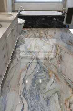 a bathroom with marble floors and white fixtures