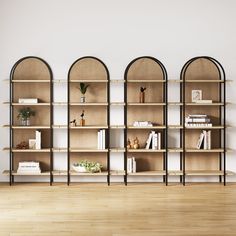 an empty room with three bookshelves on the wall and one shelf filled with books