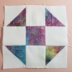 a piece of fabric with different colors and shapes on it that is being sewn together