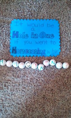 a blue sign sitting on top of a carpet next to two white balls with writing on them