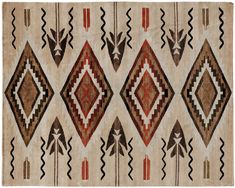 an old navajo rug with geometric designs on the front and back side, in brown, red