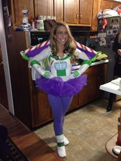 a woman dressed in costume standing next to a kitchen counter