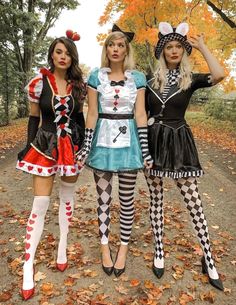 three women dressed in costumes posing for the camera