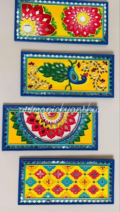 three colorful wall hangings with flowers and leaves painted on the side of each one