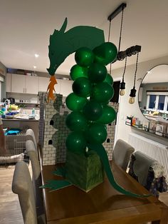 the balloon sculpture is made to look like a fish on top of a tree branch