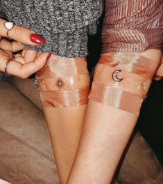 two women with sun and moon tattoos on their legs, both wearing sheer gauze