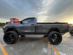 a gray truck parked in a parking lot