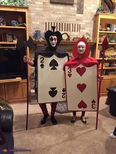 two people in costumes holding playing cards