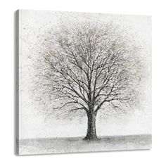 a black and white tree with snow on it's branches is featured in an art print