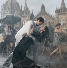 a man and woman dancing in the rain