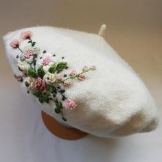 a white hat with flowers on it