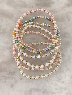 Introducing our new colorful stackable beaded bracelets. Each bracelet is 14k gold filled and comes with a STUNNING acrylic color bead. Please note that this listing is for ONE bracelet only! These are gorgeous to stack with your already gold filled bracelet. Choose from these colors! 1. Over the Rainbow (Rainbow boho colors) 2. Sky(Alternating blue and white) 3. Daisy (White) 4. Mint Chip (Mint colored) 5. Cotton Candy (Light Pink) These do not tarnish and are gold filled! Beaded Diy Bracelets, Beaded Stack Bracelets, Diy Gold Bead Bracelets, Gold Beaded Bracelets Stack, Beaded Bracelets Stack, Stack Bracelets Beaded, Beaded Bracelet Business, Christmas Bracelets Beaded, Gold Beaded Bracelets