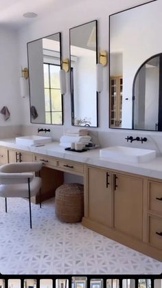 a large bathroom with double sinks and mirrors