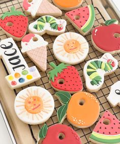 there are many decorated cookies on the tray